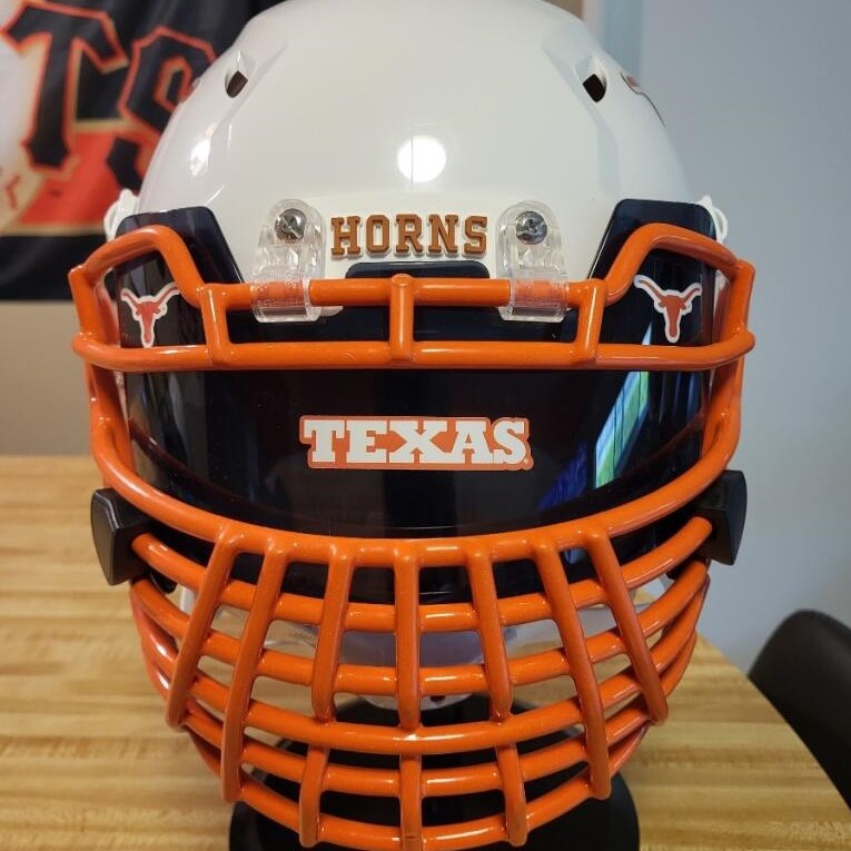 A Texas Longhorns helmet with a darkened visor and a bold decal.