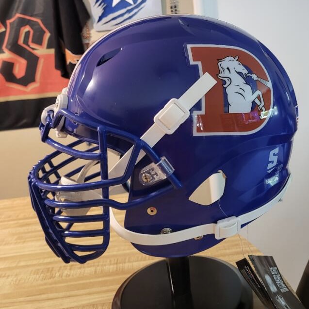 A throwback Denver broncos helmet with a logo depicting a bucking horse.